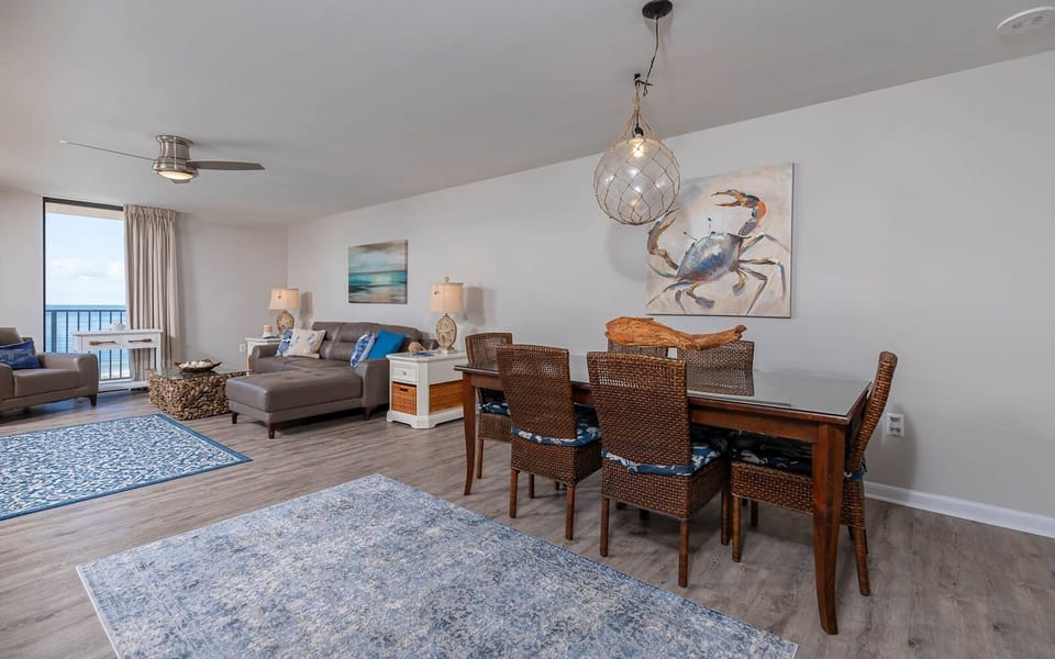 Relax in the inviting living area with comfortable seating, a dining table, and beautiful coastal decor