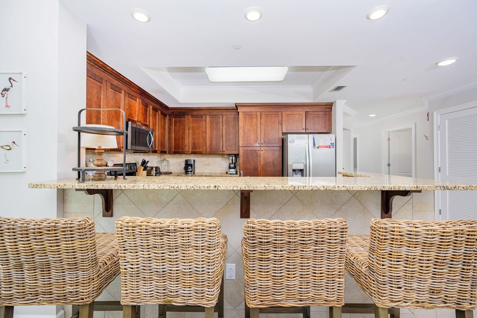 Gather at the stylish breakfast bar, perfect for enjoying meals while taking in the inviting kitchen atmosphere