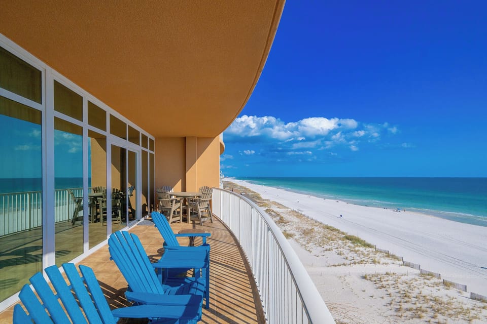 Relax on your beachfront balcony enjoying expansive views of the tranquil waters and inviting coastal vibe