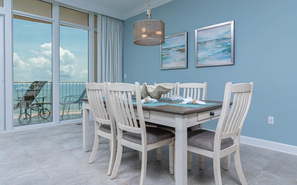 Gather around the spacious dining table, enjoying laughter and conversation with views of the inviting coast