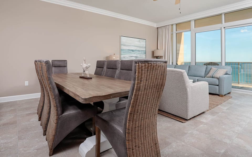 Gather around the stylish dining table, where laughter and conversation flow amid coastal breezes and light