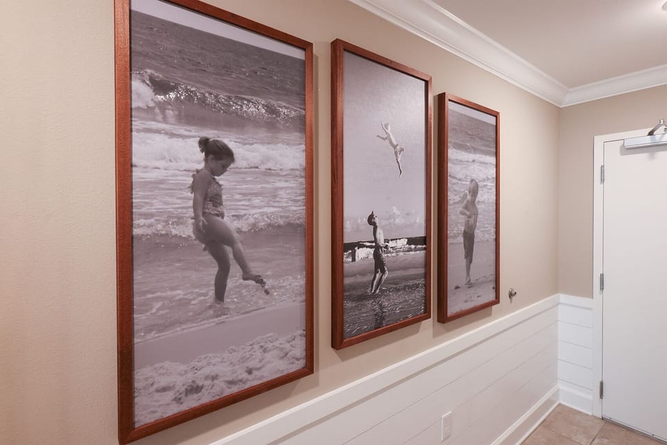 Appreciate the playful beach-themed art that sparks fond memories and invites joyful moments in your coastal retreat