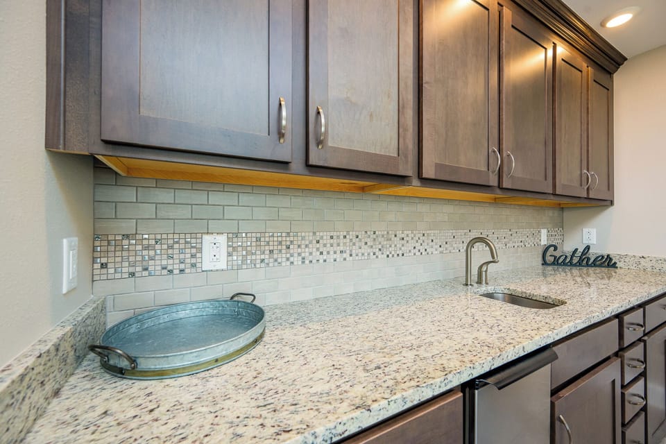 Gather with friends around the sleek wet bar, crafting cocktails as laughter fills the air in this inviting space