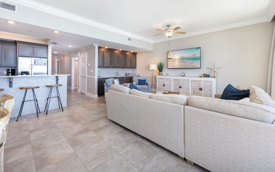 Unwind on the plush sofa as gentle breezes drift in, enhancing your relaxation in this stylish coastal retreat