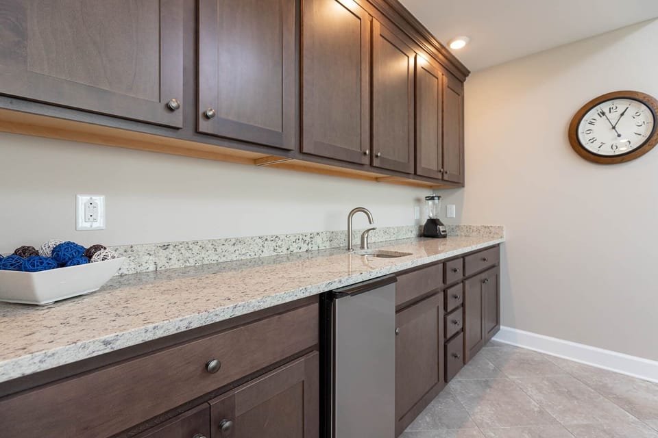 Enjoy crafting refreshing drinks at the sleek wet bar, perfect for unwinding after a day at the beach