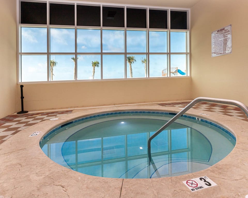 Soak in the indoor hot tub with views of swaying palm trees and a fun water slide just outside the window