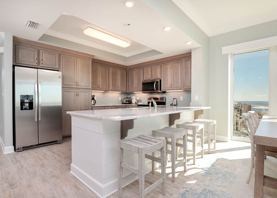Gather around the stylish breakfast bar for delightful conversations while enjoying coastal vistas