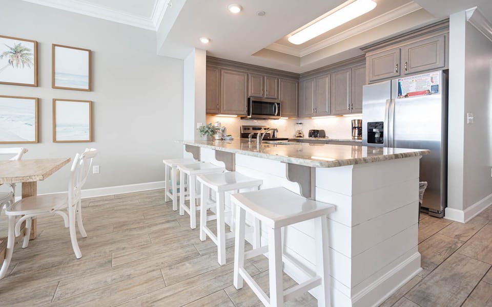 Sip your morning coffee at the breakfast bar and get ready for a beach day in this stylish space
