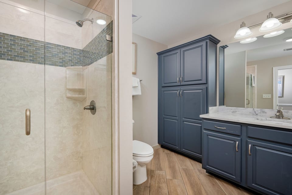 Refreshing water sprays down in the guest suite shower while you unwrap towels from the rack nearby
