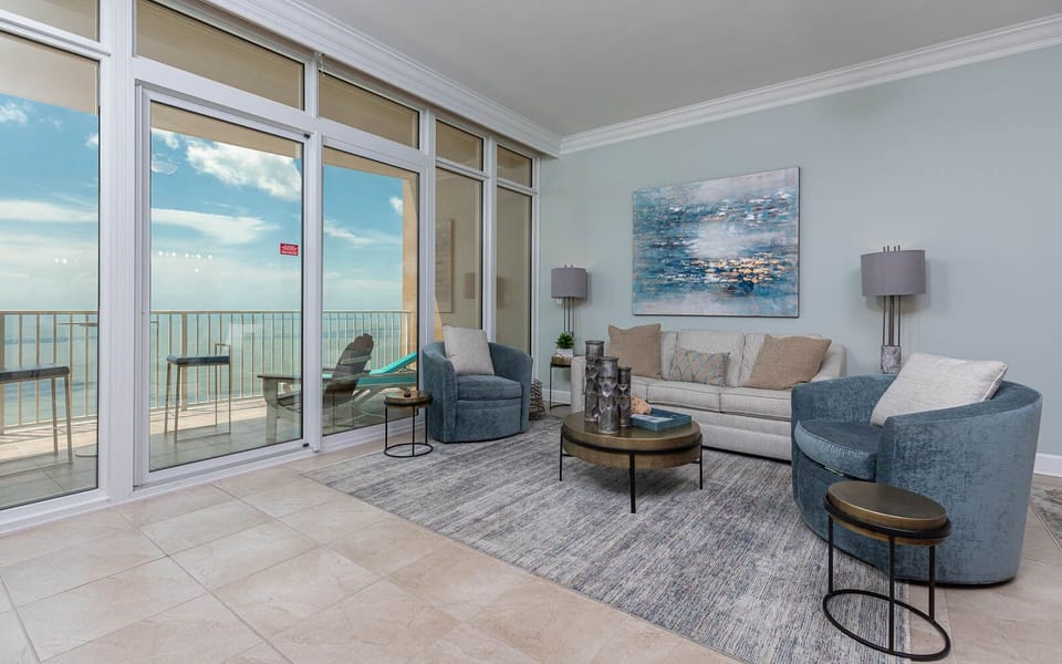 Unwind in the cozy living area, featuring a queen sofa sleeper, where beach views invite relaxation