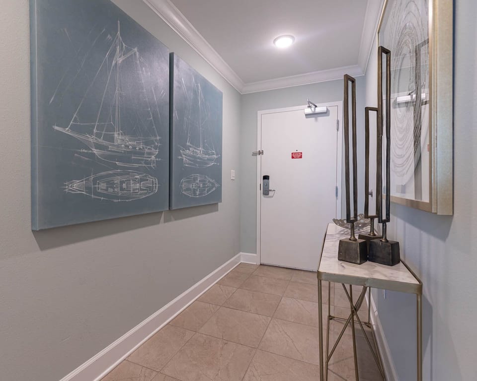 Step into a welcoming hallway adorned with nautical art, setting a charming tone for your beach getaway