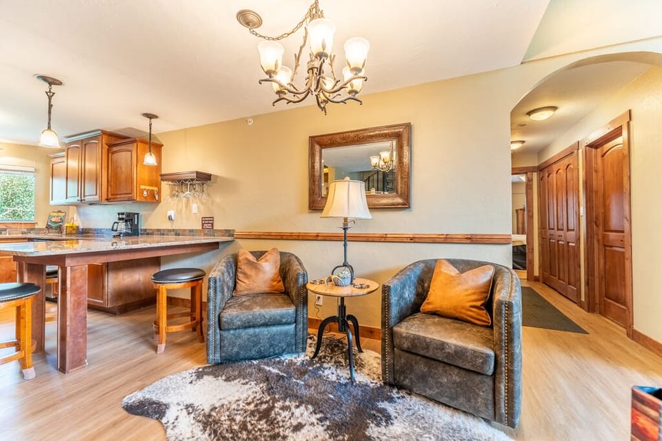 Unwind in your stylish living space with leather chairs and elegant lighting, while the full kitchen awaits your culinary adventures.