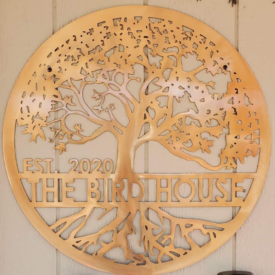 The Bird House front door sign