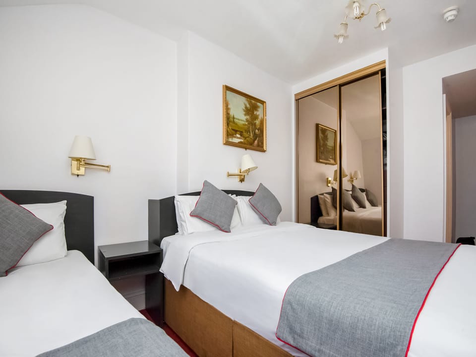 Desk, iron/ironing board, bed sheets