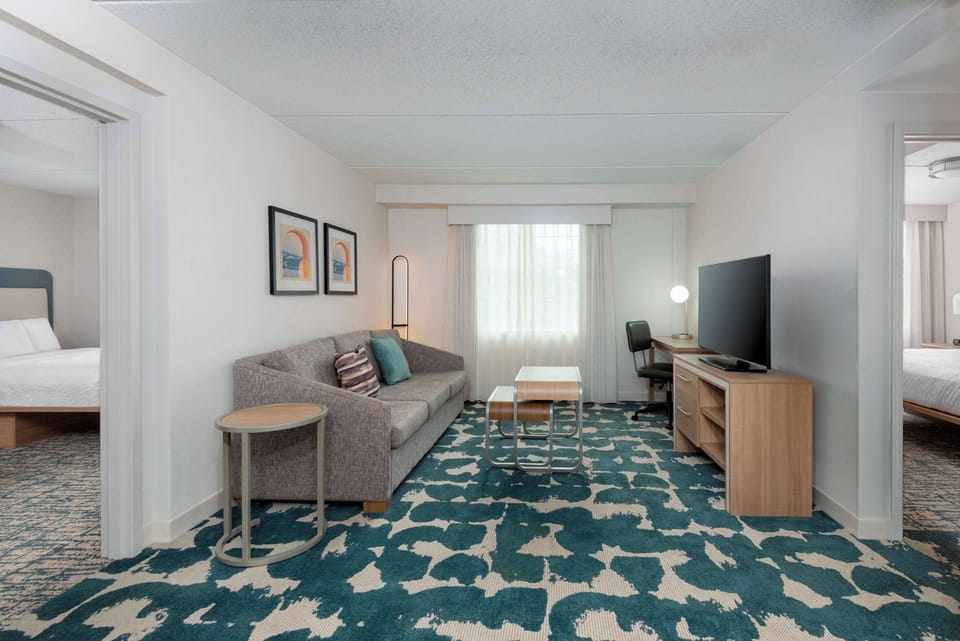 Suite, 2 Bedrooms, Non Smoking (1 King/2 Doubles) | Living area | 50-inch TV with cable channels, Netflix, foosball