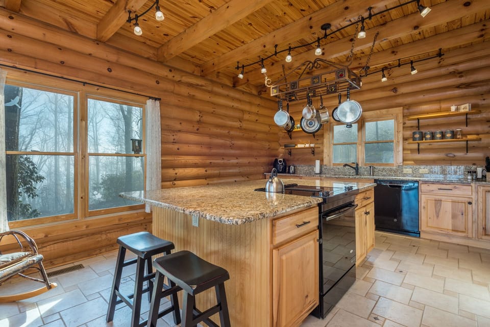 Kitchen with a dishwasher, island seating, and 2 types of coffeemakers (Drip-style & Keurig).