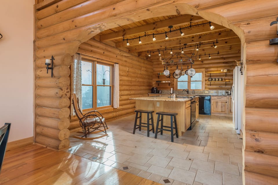 Kitchen with a dishwasher, island seating, and 2 types of coffeemakers (Drip-style & Keurig).