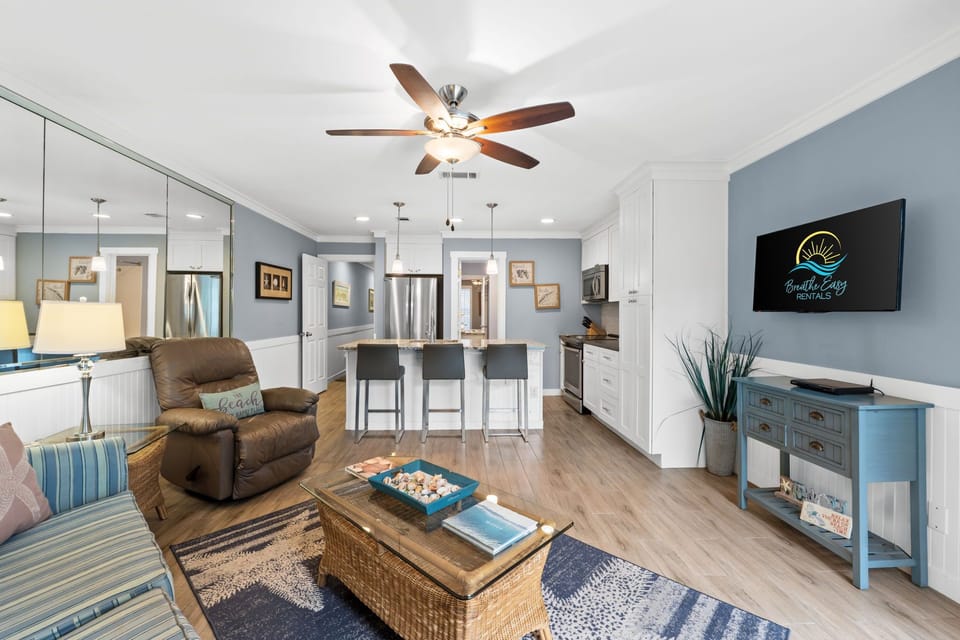 Living room featuring fresh decor done in coastal colors and art. Flat screen TV w/cable.