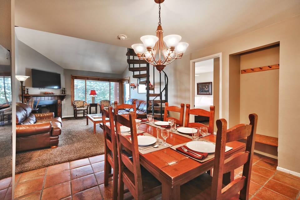 Dining area with wooden table and chairs, opens into the living room
