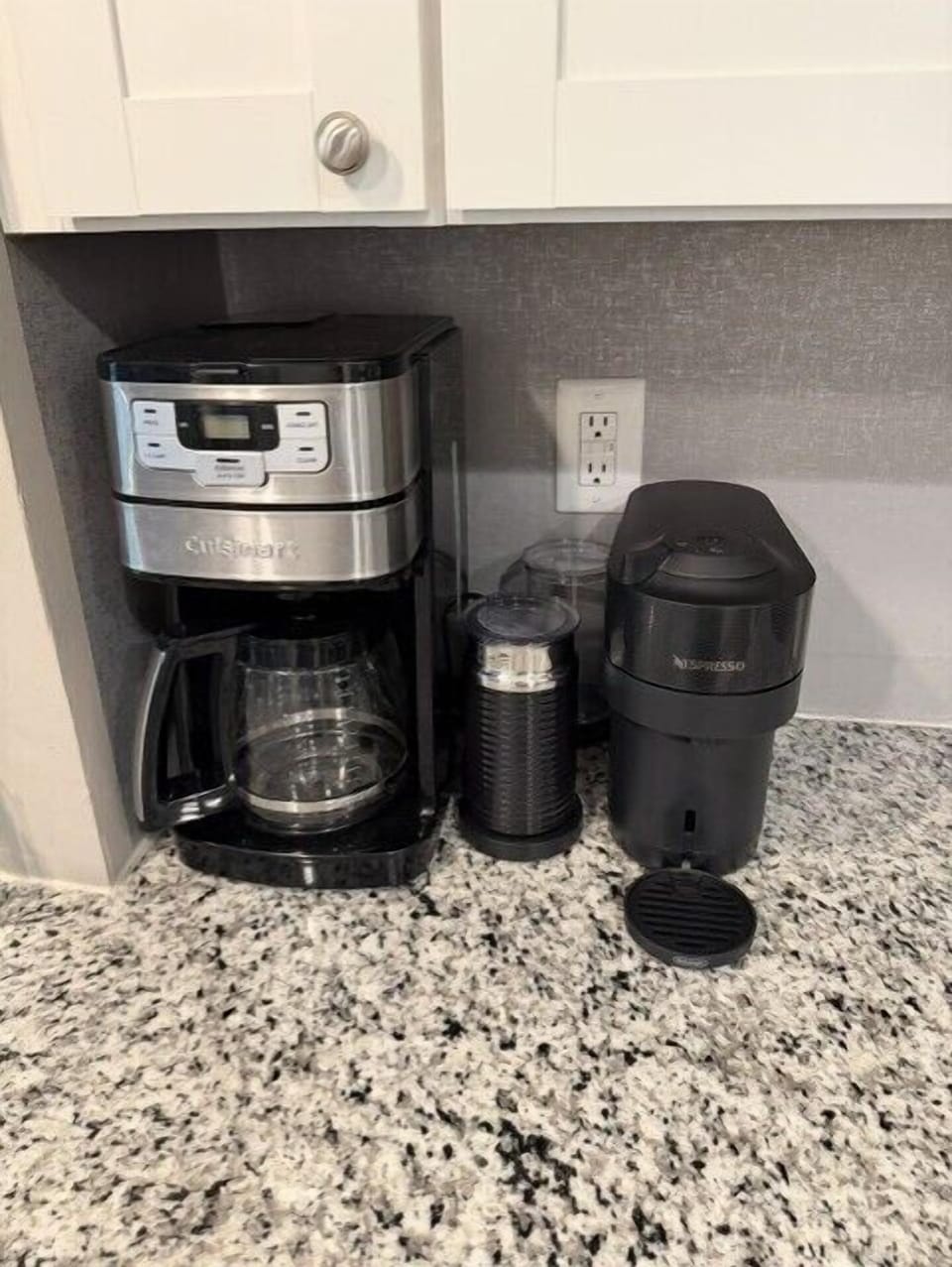 Regular coffee pot, Nespresso maker, and milk frothier available for morning coffees.