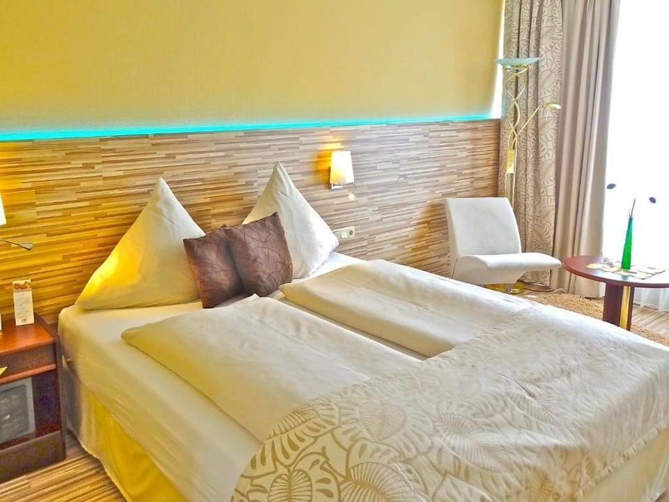 Hypo-allergenic bedding, desk, laptop workspace, blackout drapes