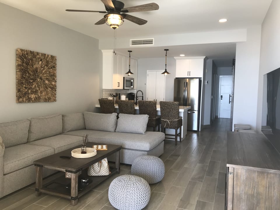 Beautiful living room with a 55” Smart TV and a Queen sofa sleeper.