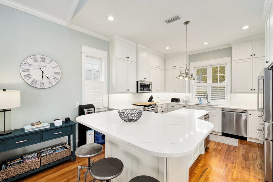 Your gourmet kitchen awaits with gleaming quartz countertops, stainless steel appliances, and a spacious island perfect for morning coffee and culinary adventures.