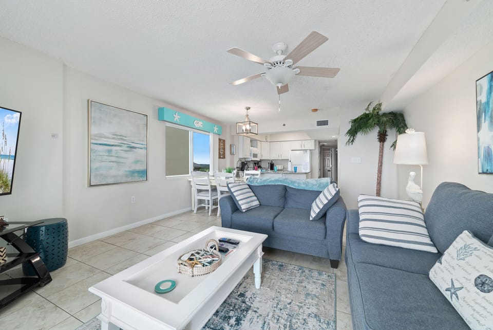 A comfortable living room with ample seating, flowing into a dining area, ideal for everyday living and gatherings.