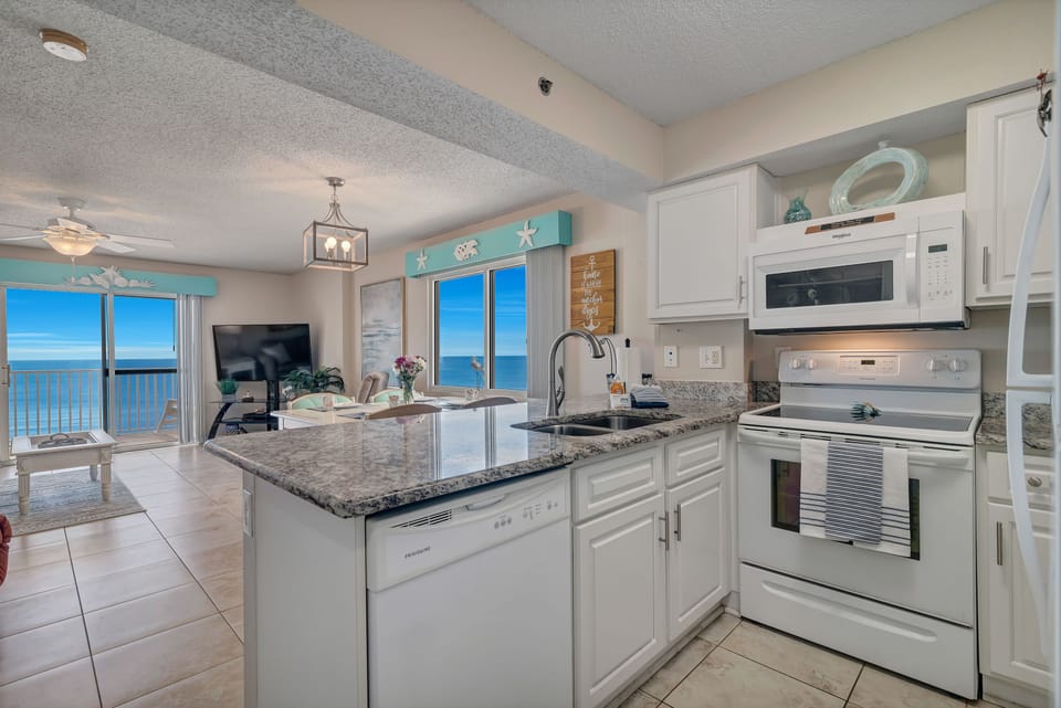 This fully functional kitchen with amazing ocean views boasts stainless steel appliances, sleek countertops, and ample cabinet storage, ideal for everyday cooking and entertaining.