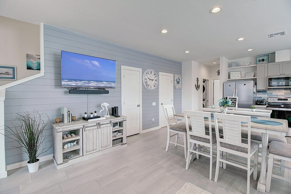 Relax in your coastal-inspired open living space where beach vibes meet modern comfort, perfect for gathering with loved ones.