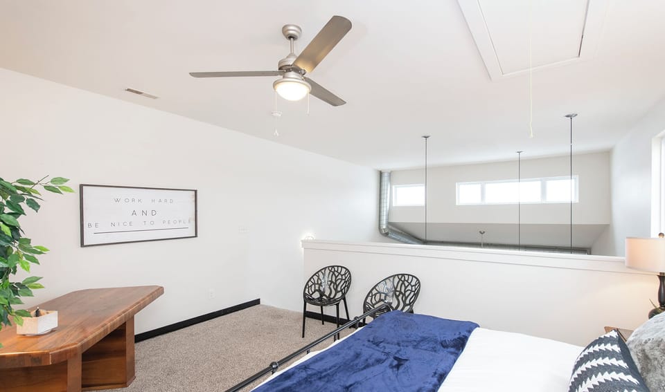 Bedroom shared with office space for guests that work and travel.