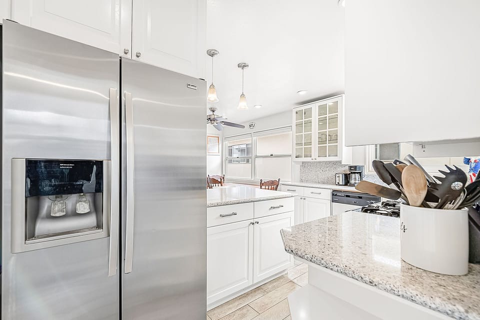 This upper unit transitions from kitchen, dining, and living room (behind dining table) seamlessly.
                