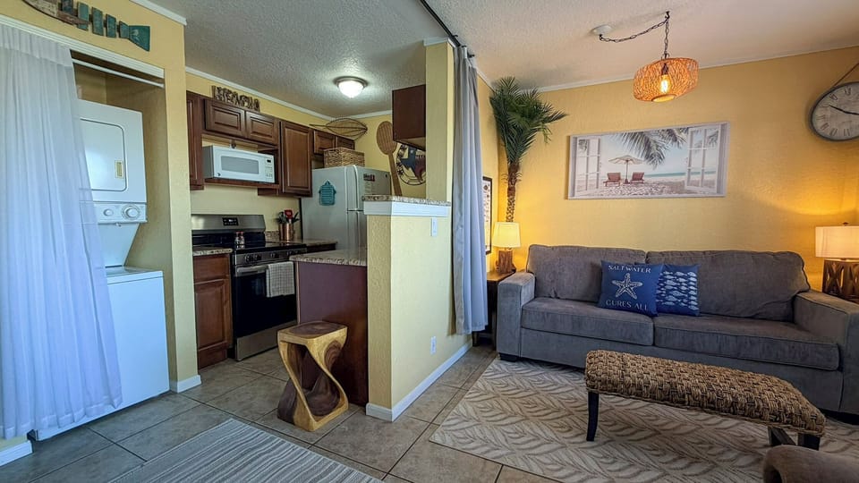 Your cozy retreat seamlessly blends kitchen and living areas, perfect for relaxing after beach days with modern amenities and coastal charm.