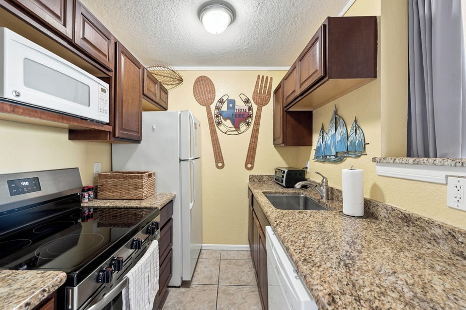 Step into your fully equipped kitchen with granite countertops, modern appliances, and everything you need to whip up your favorite meals during your stay.