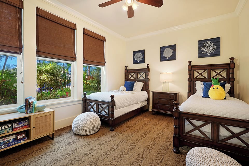 Cozy guest bedroom with twin beds and garden views, ideal for family or friends.