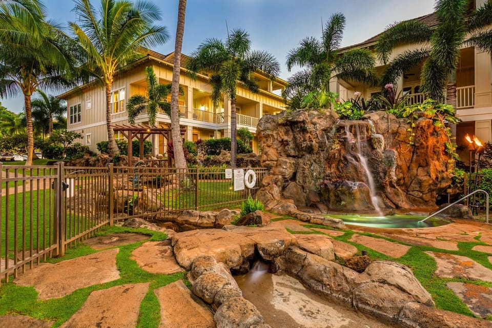 Relax in the tropical-inspired pool area with cascading waterfalls and lush landscaping.