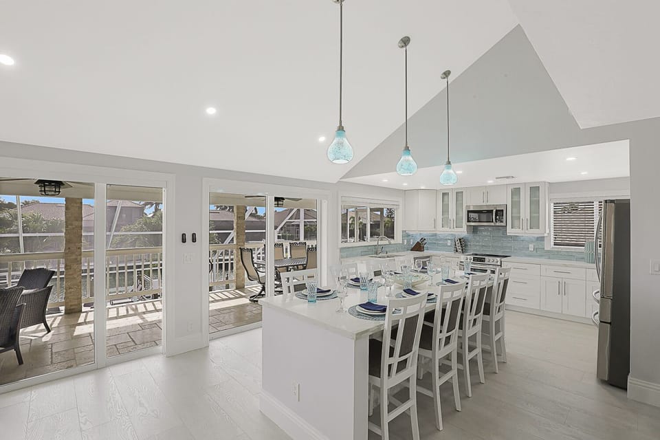 8 seat Quartz topped island kitchen with LED lighting, stainless steel appliance