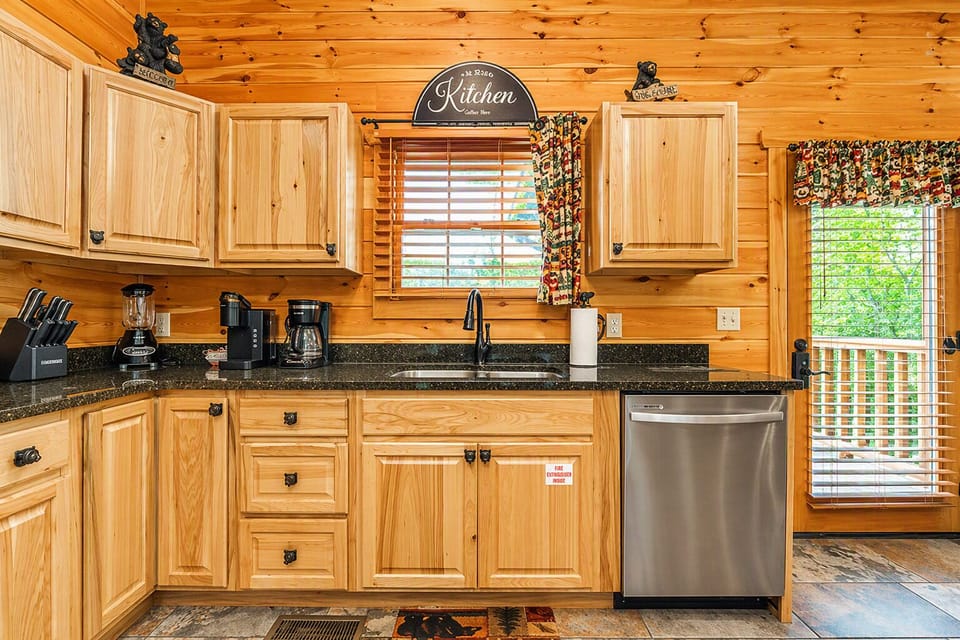 Bear‑themed kitchen stocked with a Keurig, coffee maker, blender, and crock pot for easy meal prep