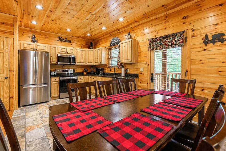 Enjoy meals at the spacious eight‑seat kitchen table, accented by handcrafted bear décor and matching placemats for a true Smoky Mountain touch