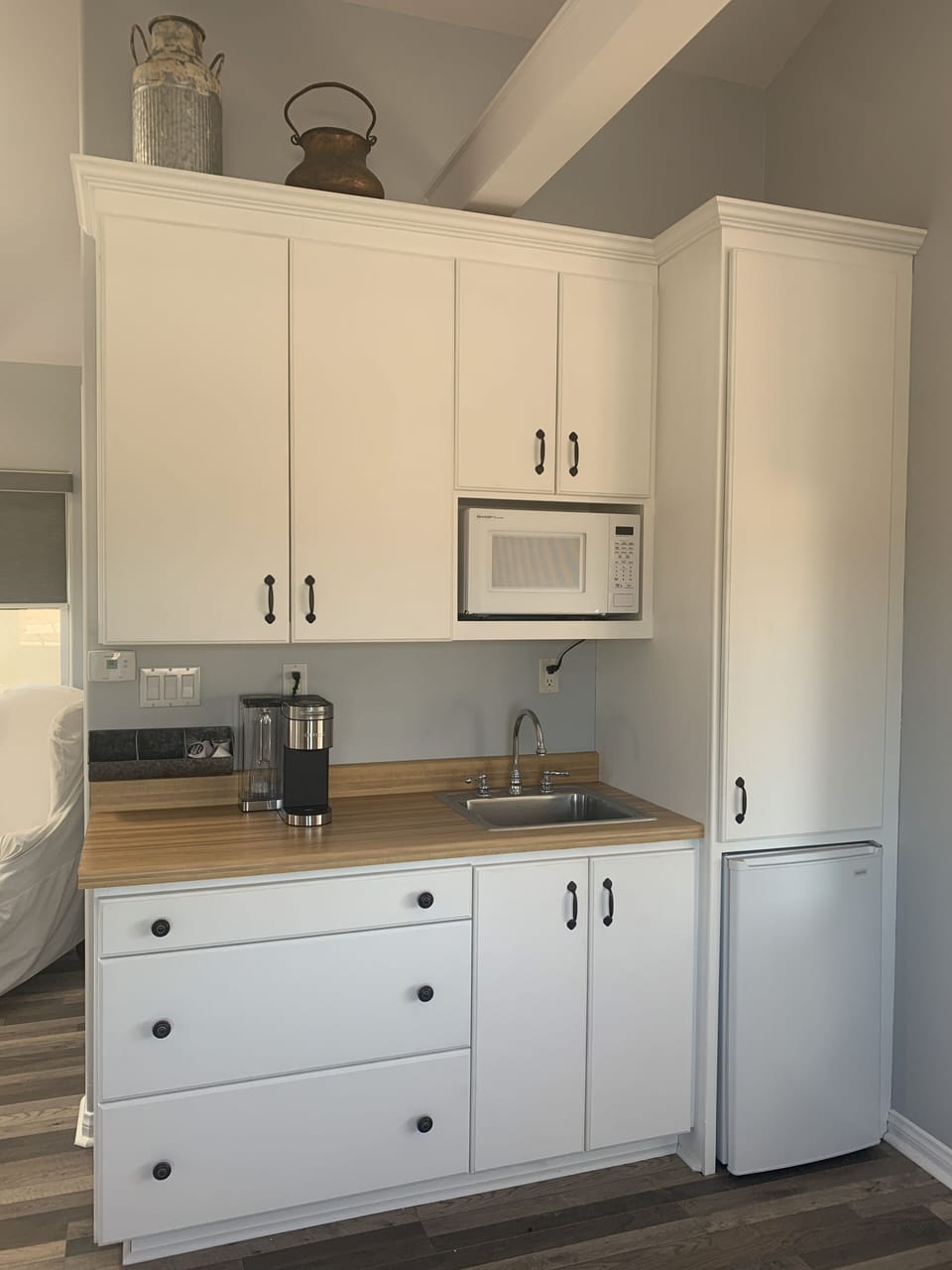 Kitchenette equipped with dishes, glasses, silverware, and complimentary coffee