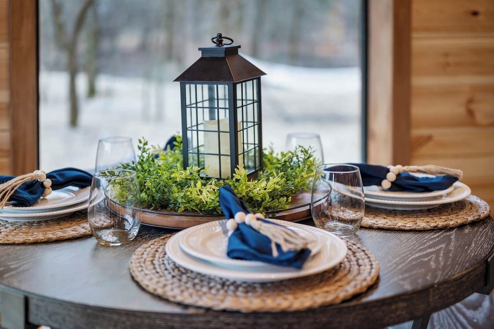 The dining table offers a great view of the woods.