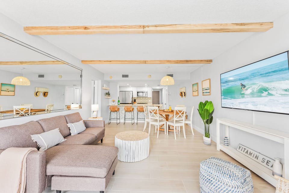 Spacious open-concept living and dining area with stylish furniture and natural wood accents.