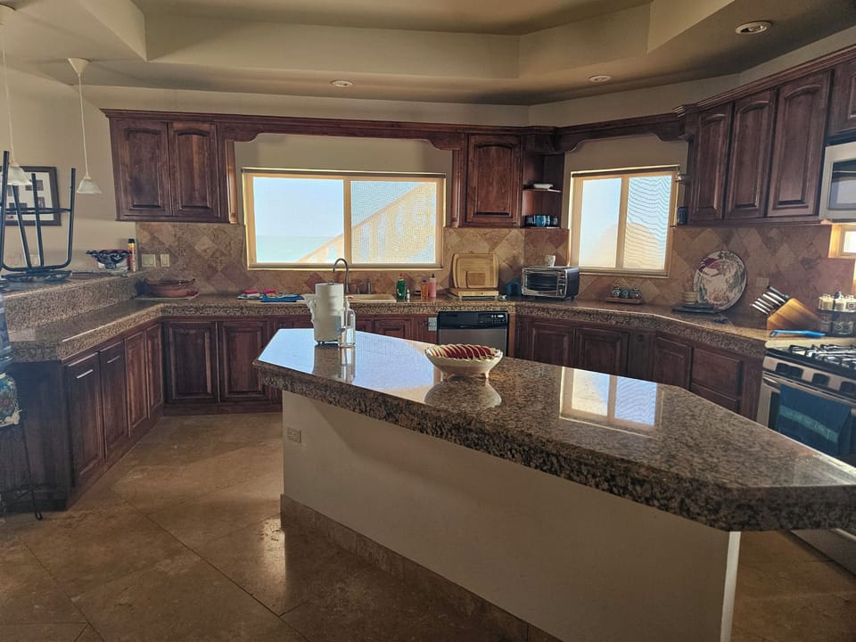 Granite & Travertine throughout. 
2 refrigerators