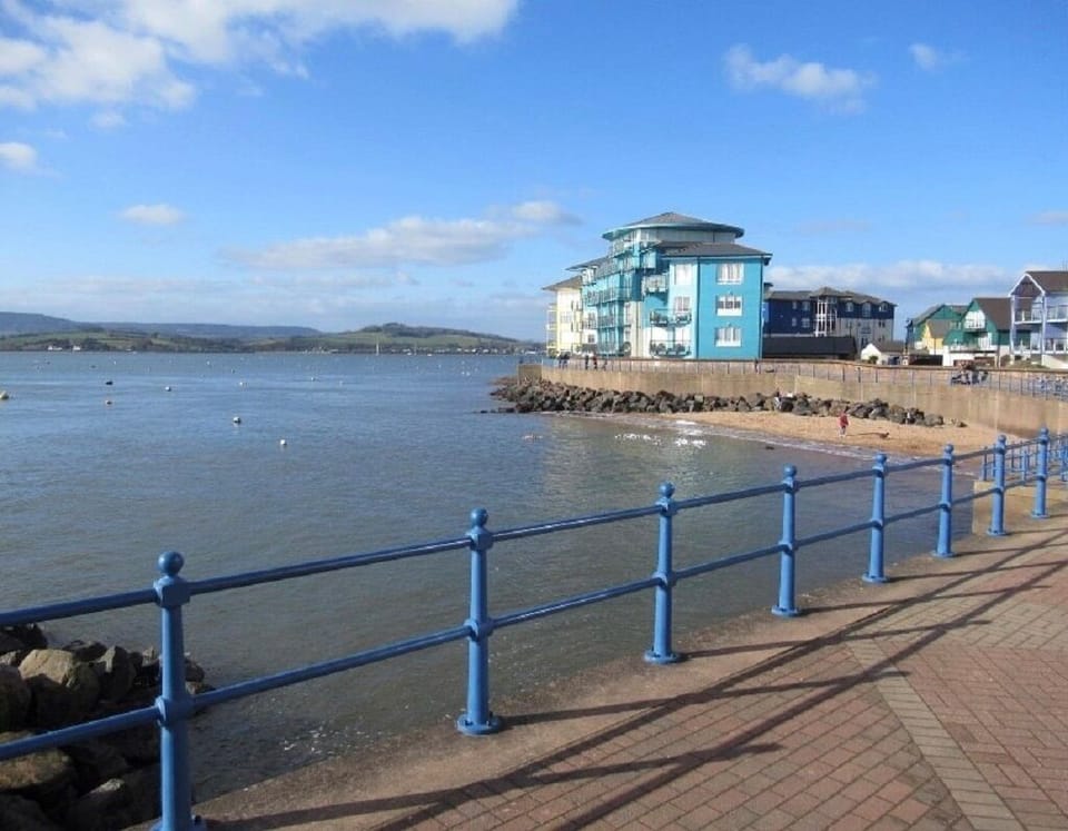 Promenade around the outside of the marina overlooking river Exe estuary  