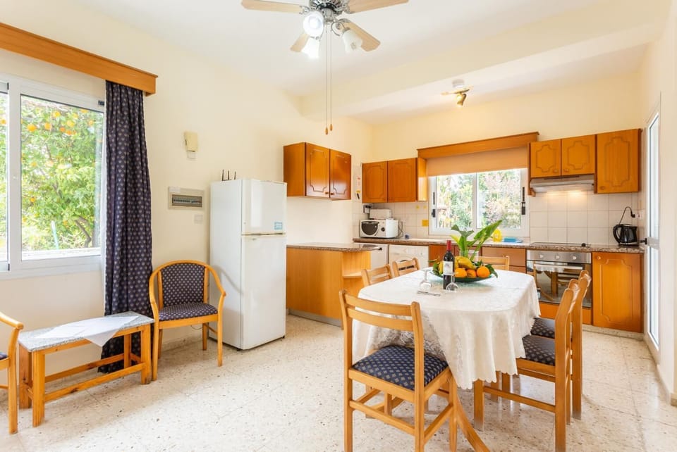 Open-plan living room with sofas, dining area, kitchen, WiFi internet, and satellite TV