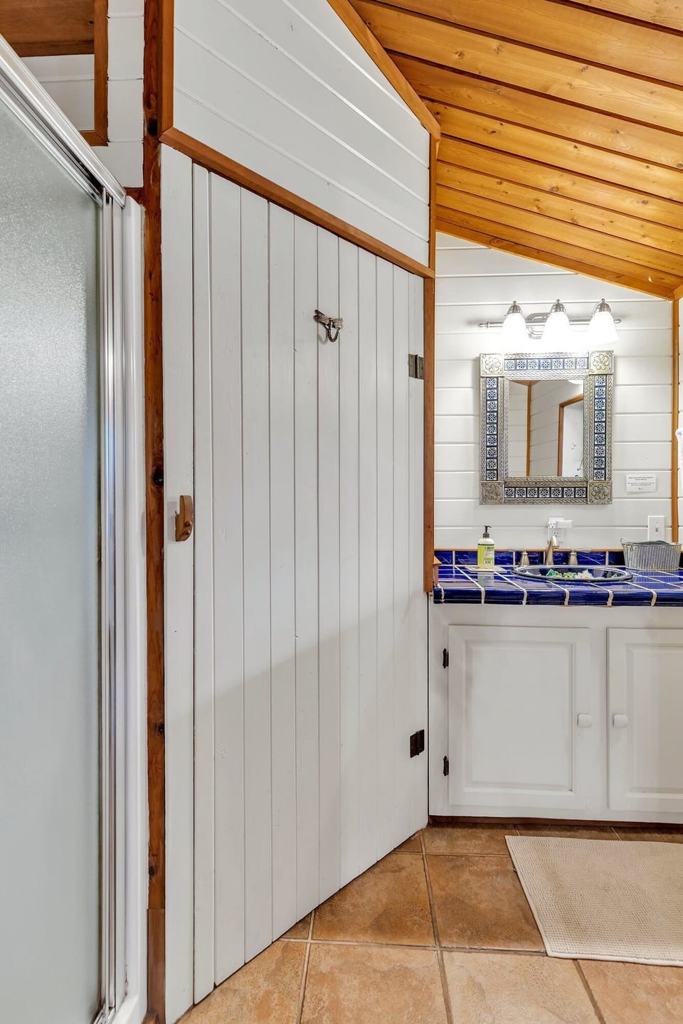 The second full size bathroom in the cabin with a shower, vanity, and toilet.