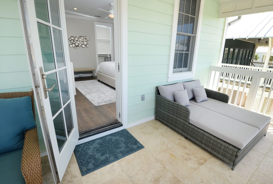 Upstairs master bedroom balcony with bed/double lounger.