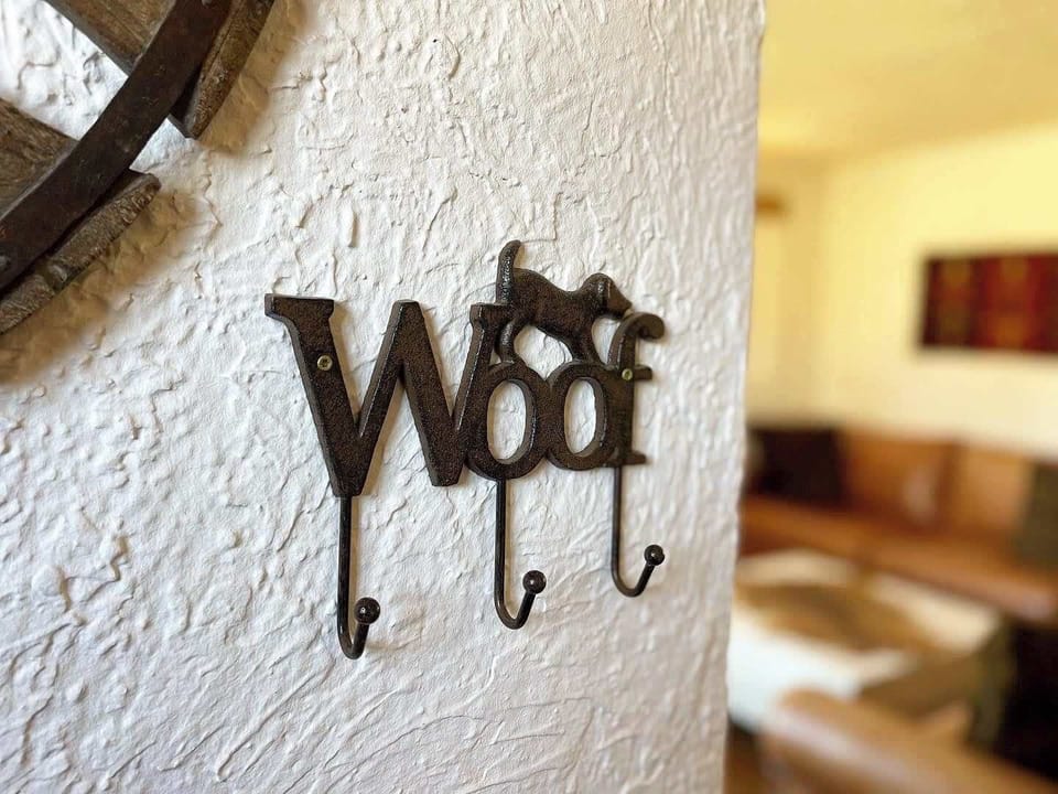 A charming "Woof" hook greets your pup at this dog-friendly Kanab adobe rental—perfect for hanging leashes by the door.