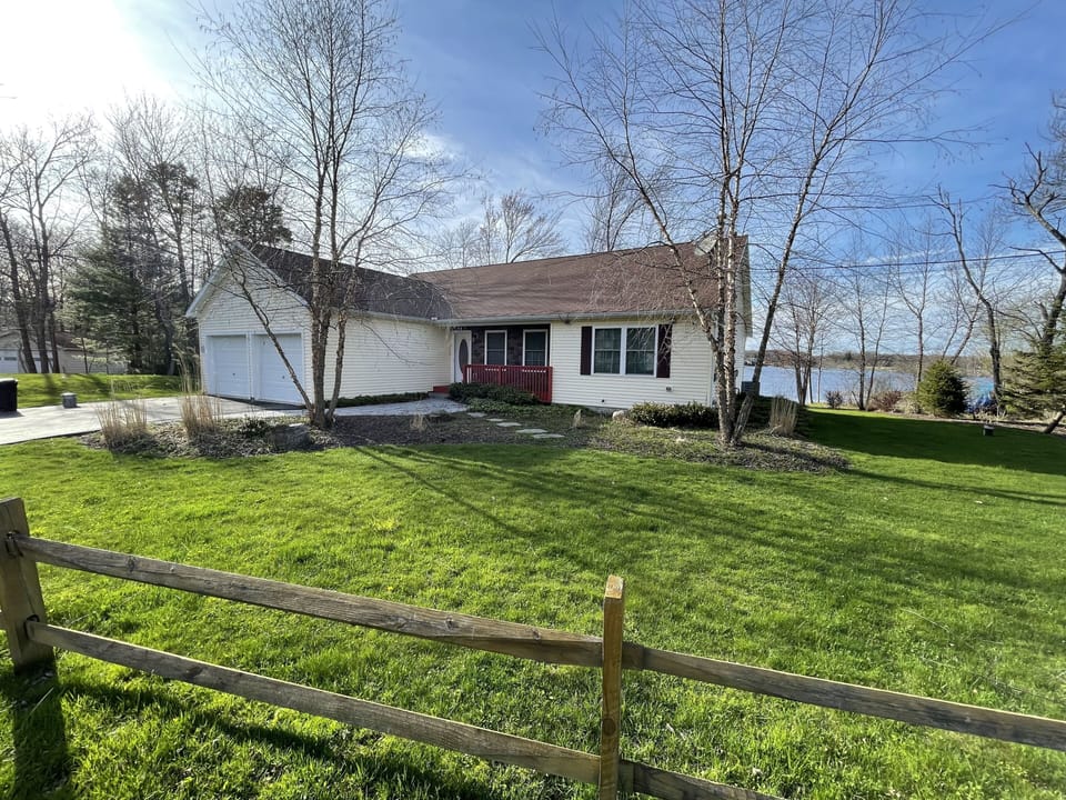 Front of house with lake in backyard