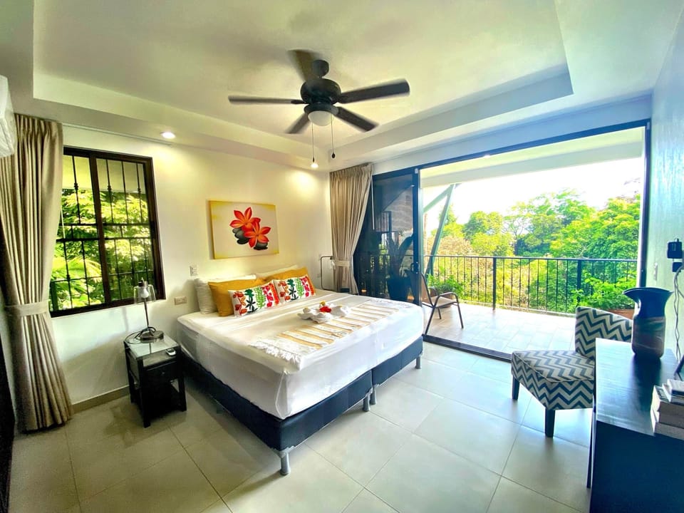 Bedroom with king bed and amazing forest and ocean view